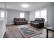 Inviting living room with hardwood floors, two loveseats, and a large TV at 200 W Shannonhouse St, Shelby, NC 28152