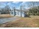 Side view of a light blue brick house with black shutters and a concrete driveway at 200 W Shannonhouse St, Shelby, NC 28152