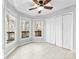 Bedroom with neutral carpet, closet, and multiple windows at 2124 Marquesas Ave, Tega Cay, SC 29708