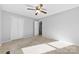 Neutral bedroom featuring plush carpet, ceiling fan and ample closet space at 2124 Marquesas Ave, Tega Cay, SC 29708