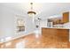 Cozy dining area with natural light, wood floors, and access to the kitchen and outdoor deck at 2124 Marquesas Ave, Tega Cay, SC 29708