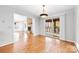 Dining area with hardwood floors, fireplace view, and access to screened porch at 2124 Marquesas Ave, Tega Cay, SC 29708
