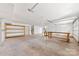 Large garage space with workbench, shelving, and two garage doors at 2124 Marquesas Ave, Tega Cay, SC 29708