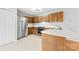 Kitchen with stainless steel appliances, wood cabinets, and tile flooring at 2124 Marquesas Ave, Tega Cay, SC 29708