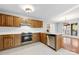 Kitchen featuring wood cabinets, stainless steel appliances, and tile flooring at 2124 Marquesas Ave, Tega Cay, SC 29708