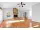 Spacious living room with stone fireplace, wood floors, and vaulted ceiling at 2124 Marquesas Ave, Tega Cay, SC 29708