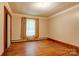 Simple bedroom with hardwood floors, closet, and a window offering natural light at 235 John Rainey Rd, Salisbury, NC 28147