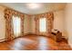 Bright bedroom with hardwood floors and floral curtains, offering a comfortable space at 235 John Rainey Rd, Salisbury, NC 28147