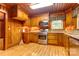 Warm-toned kitchen featuring wood cabinets, granite counters, and modern stainless-steel appliances at 235 John Rainey Rd, Salisbury, NC 28147