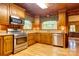 Cozy kitchen with wood cabinets, granite countertops, and stainless steel appliances at 235 John Rainey Rd, Salisbury, NC 28147