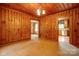 Cozy living room featuring warm wood paneling and classic chandelier lighting at 235 John Rainey Rd, Salisbury, NC 28147