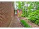 View of the side of a brick house with well-kept landscaping at 235 John Rainey Rd, Salisbury, NC 28147