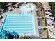 Aerial view of community swimming pool featuring water slides, splash fountain, and many umbrellas with lounge chairs at 2363 Shanklin S Ln, Denver, NC 28037