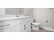 Clean bathroom with white vanity, countertop, and toilet, highlighting a functional and modern space at 2363 Shanklin S Ln, Denver, NC 28037