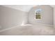 Bright bedroom with a large window providing plenty of natural light and neutral carpet flooring at 2363 Shanklin S Ln, Denver, NC 28037