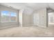 Well-lit bedroom with dormer window and neutral carpet, showcasing a cozy and inviting space at 2363 Shanklin S Ln, Denver, NC 28037