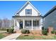 Charming two-story home with a covered front porch, decorative railings, and well-maintained landscaping at 2363 Shanklin S Ln, Denver, NC 28037