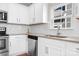 Close up of a beautifully appointed kitchen featuring stainless steel appliances and elegant white cabinets at 2363 Shanklin S Ln, Denver, NC 28037