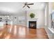 Bright and airy living room featuring hardwood floors, fireplace, ceiling fan and natural light at 2363 Shanklin S Ln, Denver, NC 28037