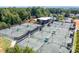 Aerial view of tennis courts and clubhouse surrounded by mature trees, and lush landscaping in a residential community at 2363 Shanklin S Ln, Denver, NC 28037