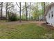 A spacious backyard with mature trees offers a serene outdoor space for relaxation and recreation at 2408 Dora Dr, Charlotte, NC 28215
