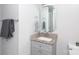 Updated bathroom featuring a granite vanity, octagonal mirror, and modern fixtures at 2408 Dora Dr, Charlotte, NC 28215