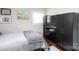 Bedroom features hardwood floors, ample natural light and a black media center at 2408 Dora Dr, Charlotte, NC 28215