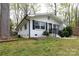 Charming brick home with black shutters, a landscaped yard, and a stone garden bed at 2408 Dora Dr, Charlotte, NC 28215