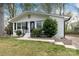 Charming brick home with well-manicured lawn, stone retaining wall and black trim at 2408 Dora Dr, Charlotte, NC 28215