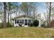 Lovely one-story home showcasing green lawn, trimmed bushes and black trimmed windows at 2408 Dora Dr, Charlotte, NC 28215