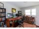 Comfortable home office featuring a work desk, lots of bookshelf space, and natural light at 2408 Dora Dr, Charlotte, NC 28215