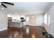 Bright kitchen with white cabinets, stainless steel appliances, and granite countertops flows into living area at 2408 Dora Dr, Charlotte, NC 28215