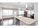 Bright open kitchen features island and view to living area at 2408 Dora Dr, Charlotte, NC 28215
