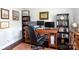 Home office with built-in bookshelves, a large desk, and a comfortable office chair at 2408 Dora Dr, Charlotte, NC 28215