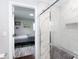 Elegant bathroom shower with white marble tile and a glass door, connected to a bedroom at 2408 Dora Dr, Charlotte, NC 28215