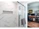 Modern bathroom shower with stylish tile and glass door, connected to home office at 2408 Dora Dr, Charlotte, NC 28215
