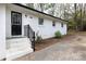 White brick ranch house featuring black trim, black railing and an entrance with steps at 2408 Dora Dr, Charlotte, NC 28215