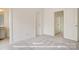 Carpeted bedroom featuring multiple doorways, neutral tones, and an additional bathroom at 282 Gilead Rd, Huntersville, NC 28078