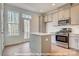 Modern kitchen featuring stainless steel appliances, gray cabinets and a kitchen island at 282 Gilead Rd, Huntersville, NC 28078