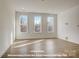 Bright living room with large windows and neutral walls, offering a versatile living space at 282 Gilead Rd, Huntersville, NC 28078