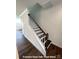Open oak tread stairs with white risers and stained handrail detail at 282 Gilead Rd, Huntersville, NC 28078