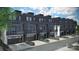 Back exterior view of modern townhomes, featuring two-car garages and gray color scheme at 2504 Park Rose Ln # 18, Charlotte, NC 28204