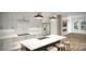 Bright kitchen with white cabinetry, center island, stainless steel appliances, and modern lighting at 2504 Park Rose Ln # 18, Charlotte, NC 28204