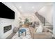 Open-concept living room with fireplace, modern furniture and staircase, blending comfort and style at 2516 Park Rose Ln # 15, Charlotte, NC 28204