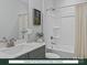 Clean, well-lit bathroom with a shower-tub combo, vanity, and tile flooring at 284 Gilead Rd, Huntersville, NC 28078