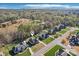 Aerial view of a house with a pool and landscaping in a suburban area with mature trees and scenic surroundings at 304 Wintergreen Ct, Kings Mountain, NC 28086
