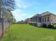 Expansive backyard with lush lawn, brick fence and screened in porch, perfect for outdoor living at 304 Wintergreen Ct, Kings Mountain, NC 28086