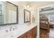 Bathroom features a double vanity with framed mirrors, wood cabinets, and neutral paint at 304 Wintergreen Ct, Kings Mountain, NC 28086