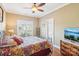 Bedroom featuring a bed, window with shutters, ceiling fan, and television on a dresser at 304 Wintergreen Ct, Kings Mountain, NC 28086