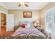 Well-lit bedroom features wood floors, a ceiling fan, and a decorative metal bed frame at 304 Wintergreen Ct, Kings Mountain, NC 28086